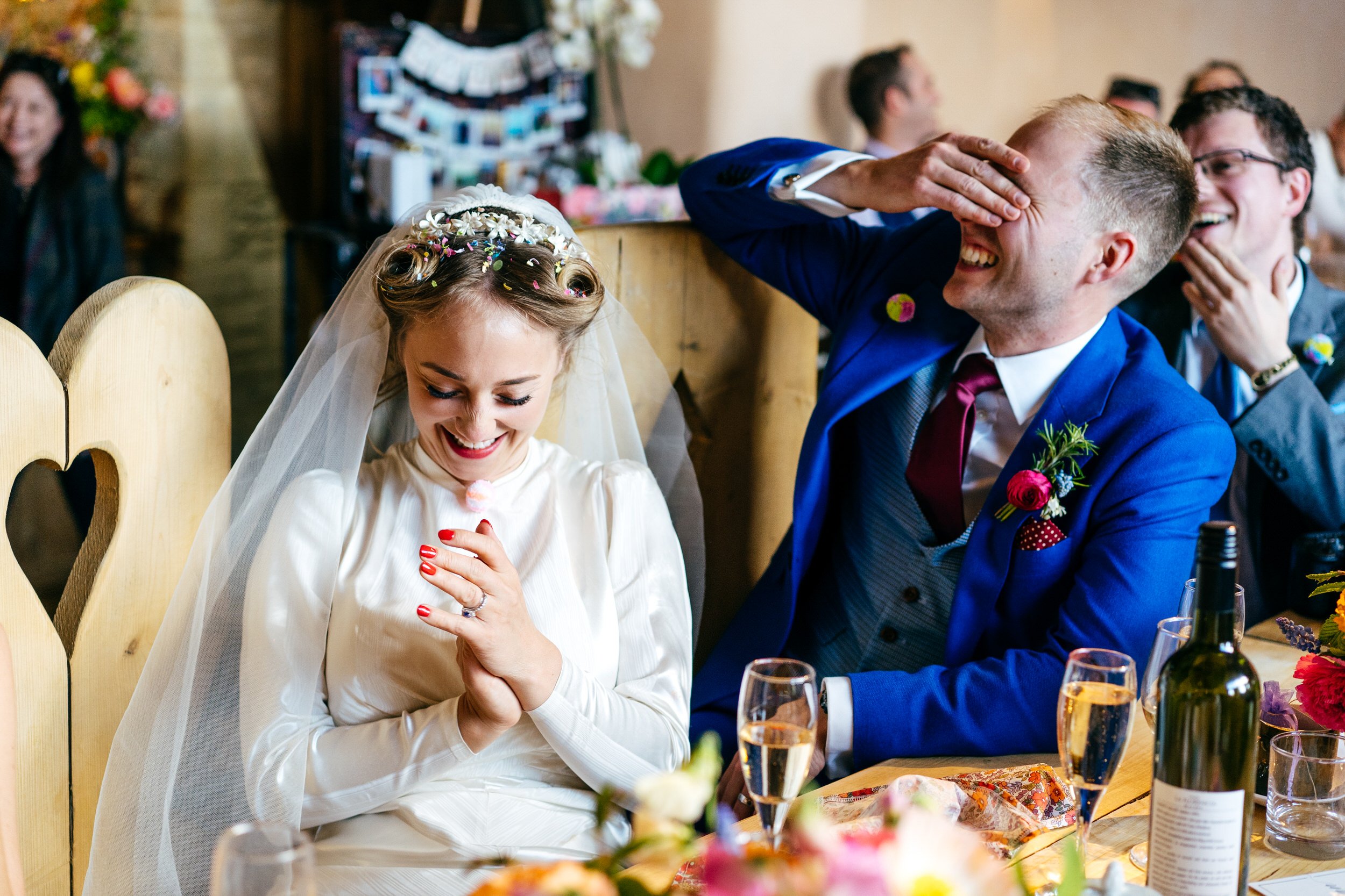 Documentary Wedding Photography approach helps overcome awkwardness bride and groom laughing during speeches at Oxleaze Barn