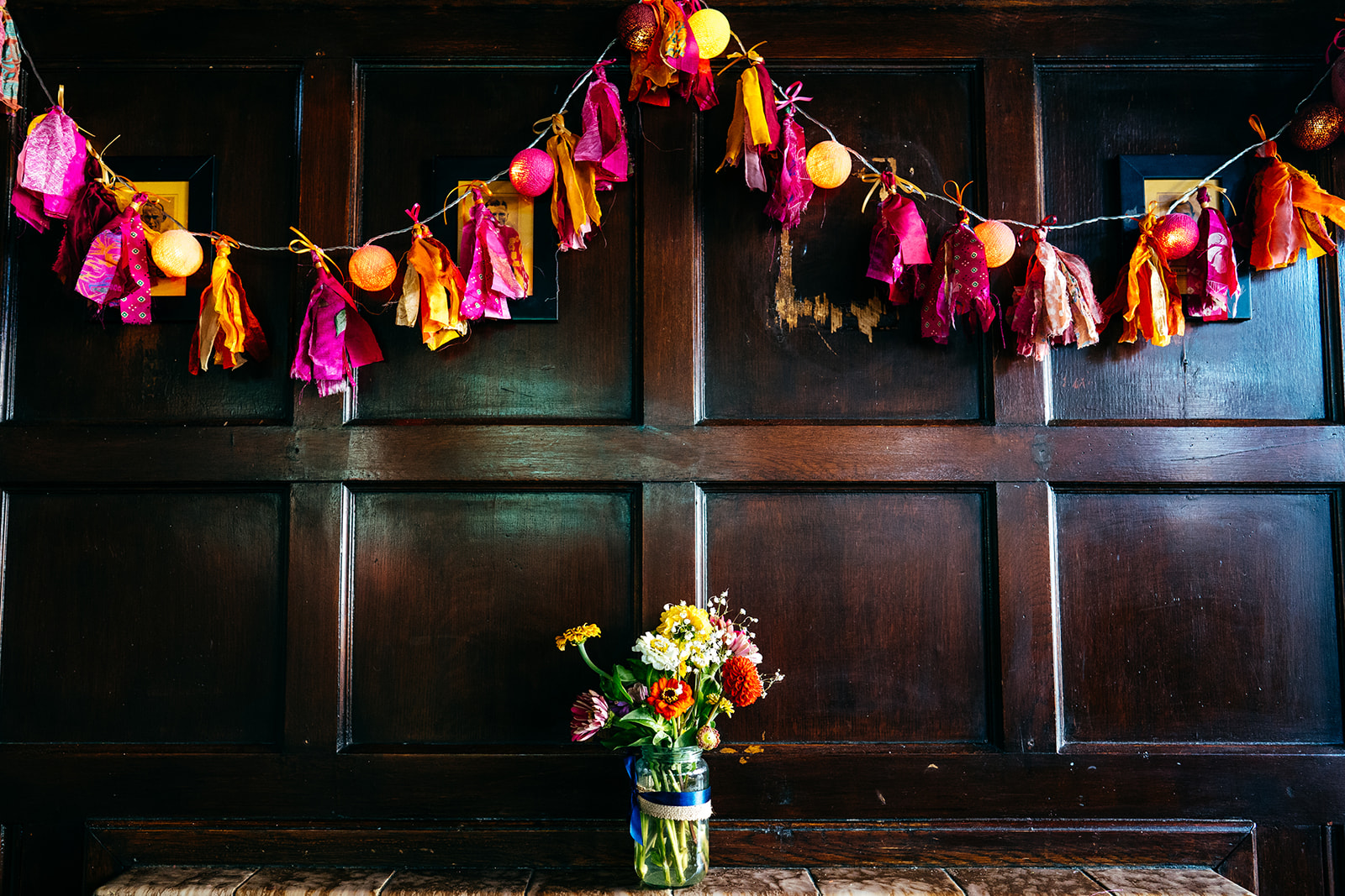 Bride made all her own wedding decorations pictured flowers and tassels in hot orange and pink