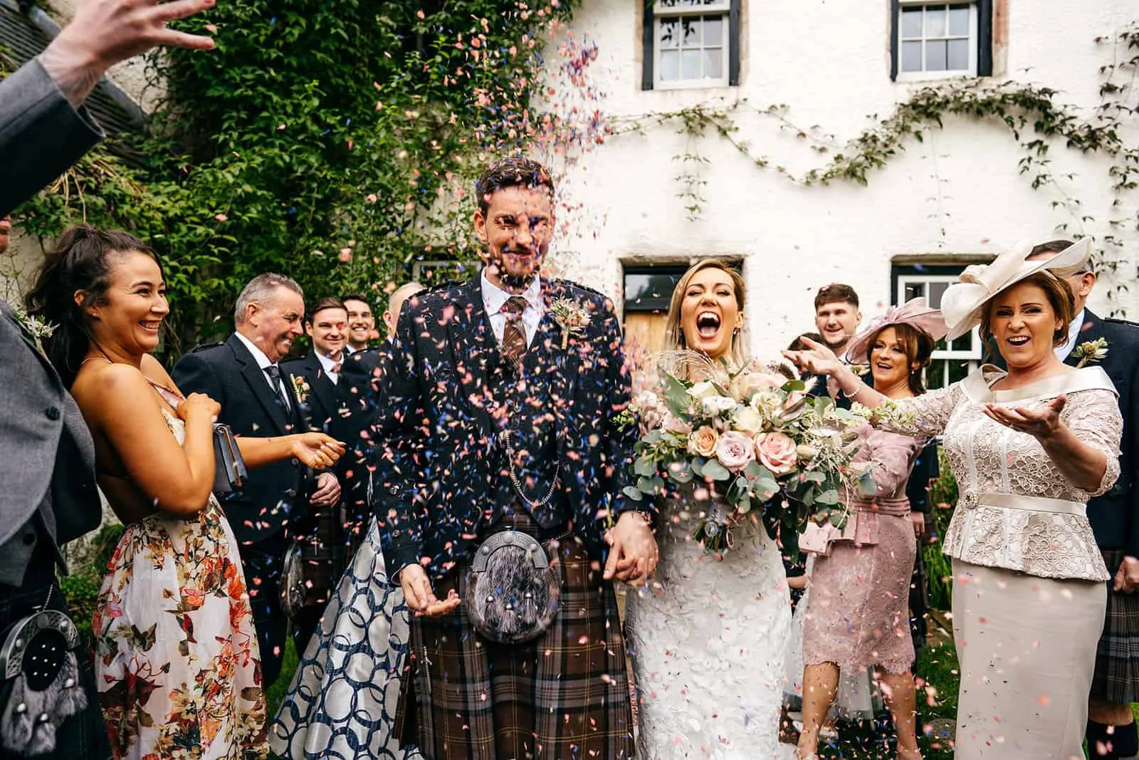 Couple walking confetti walk at wedding in Aberdeen