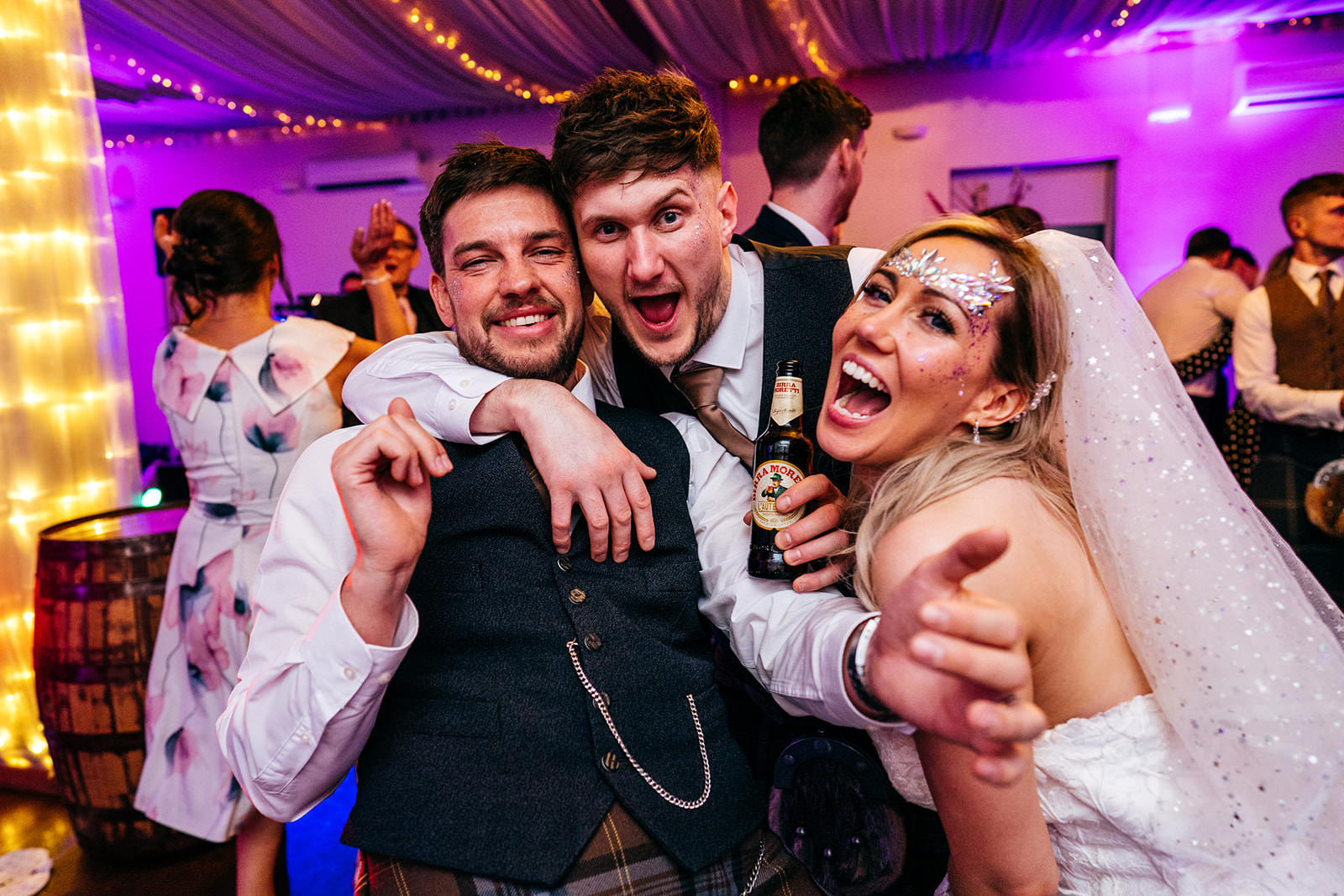 Bride and groom rather drunk with guest 