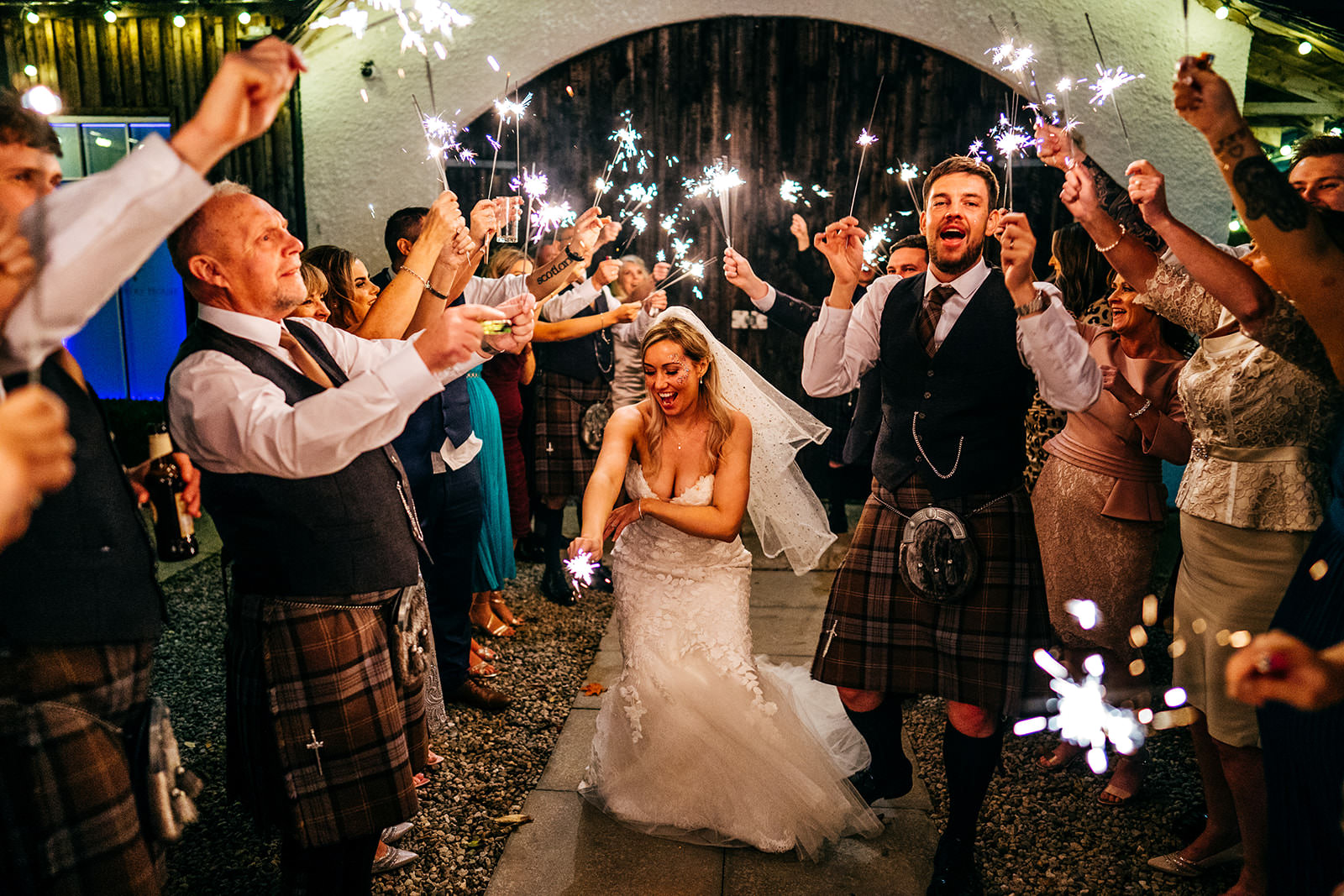 Bride and Groom dance with sparklers outside of Logie House 
