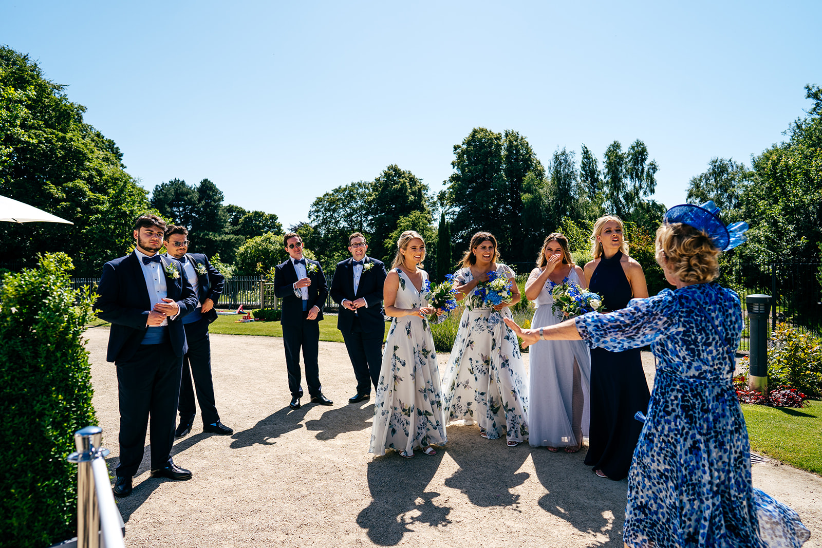 Mother of the groom welcomes wedding party at Sefton Park Palm House Wedding in Liverpool on a scorching hot summer's day