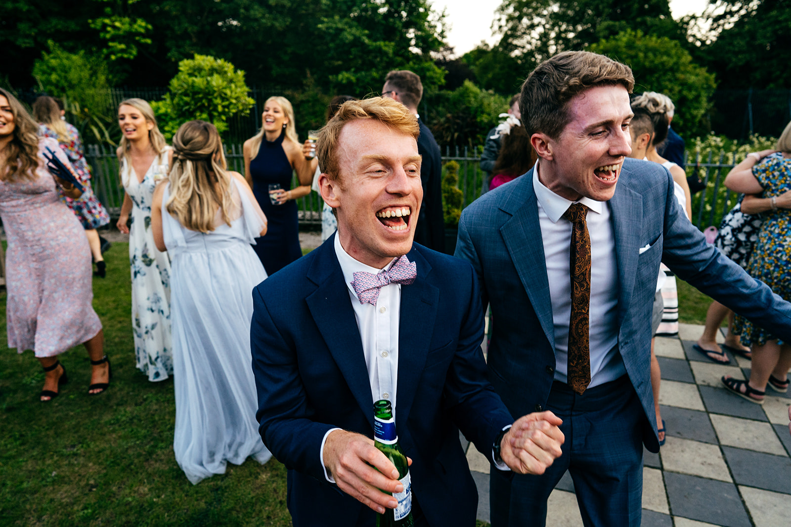 Wedding guests dancing in the gardens of Sefton Park Palm House in Liverpool