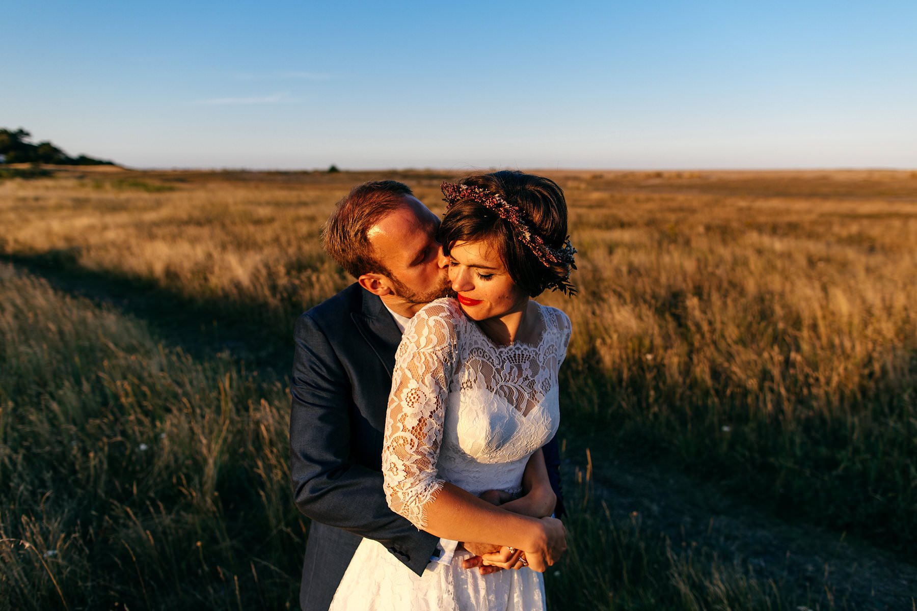 Bride and Groom cuddle up in Aldeburgh in Suffolk during golden hour