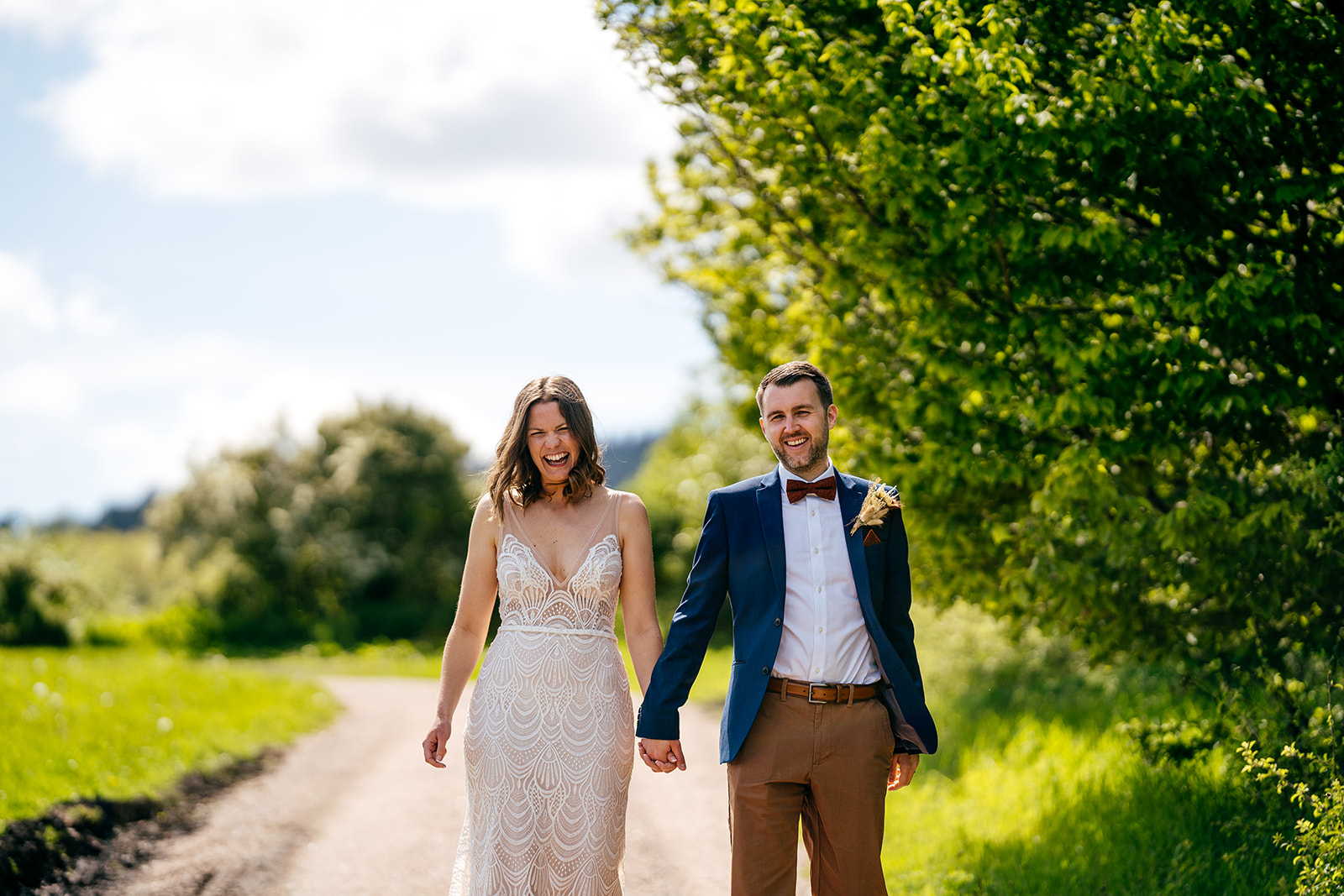 Super relaxed couple portrait in sunny Devon. Bride and Groom going for a walk. 