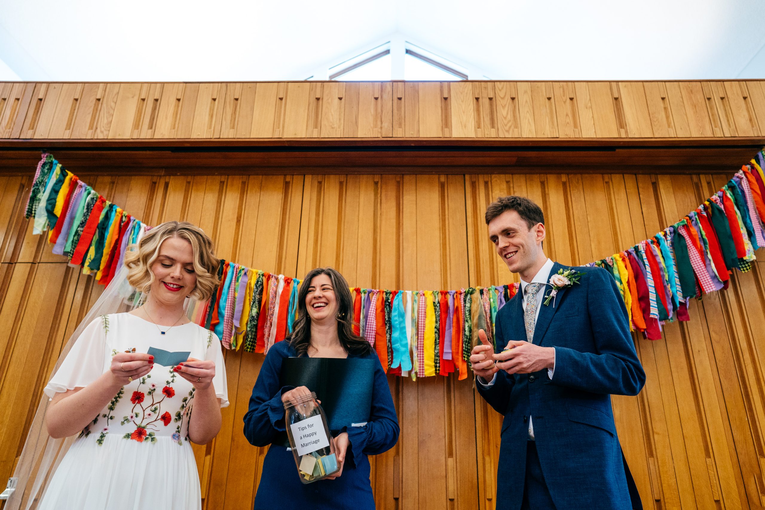Bride and Groom with Laura Grimson - Humanist Celebrant - open wedding tips from their guests during their ceremony. 