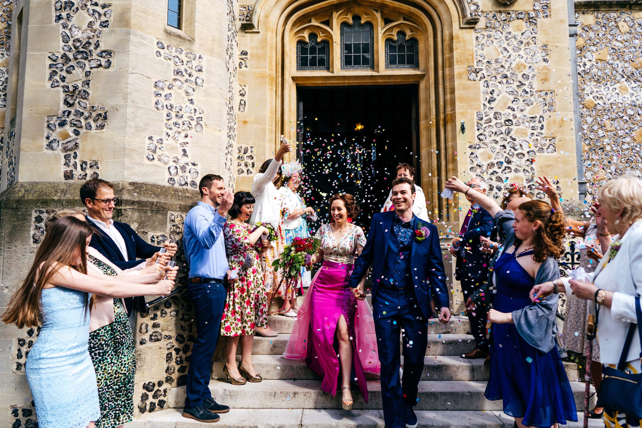 Colourful confetti moment for Gemma and Paul outside Winchester Town Hall. If you are planning a non traditional wedding then be inspired by these two lovely people who did things entirely their way. 