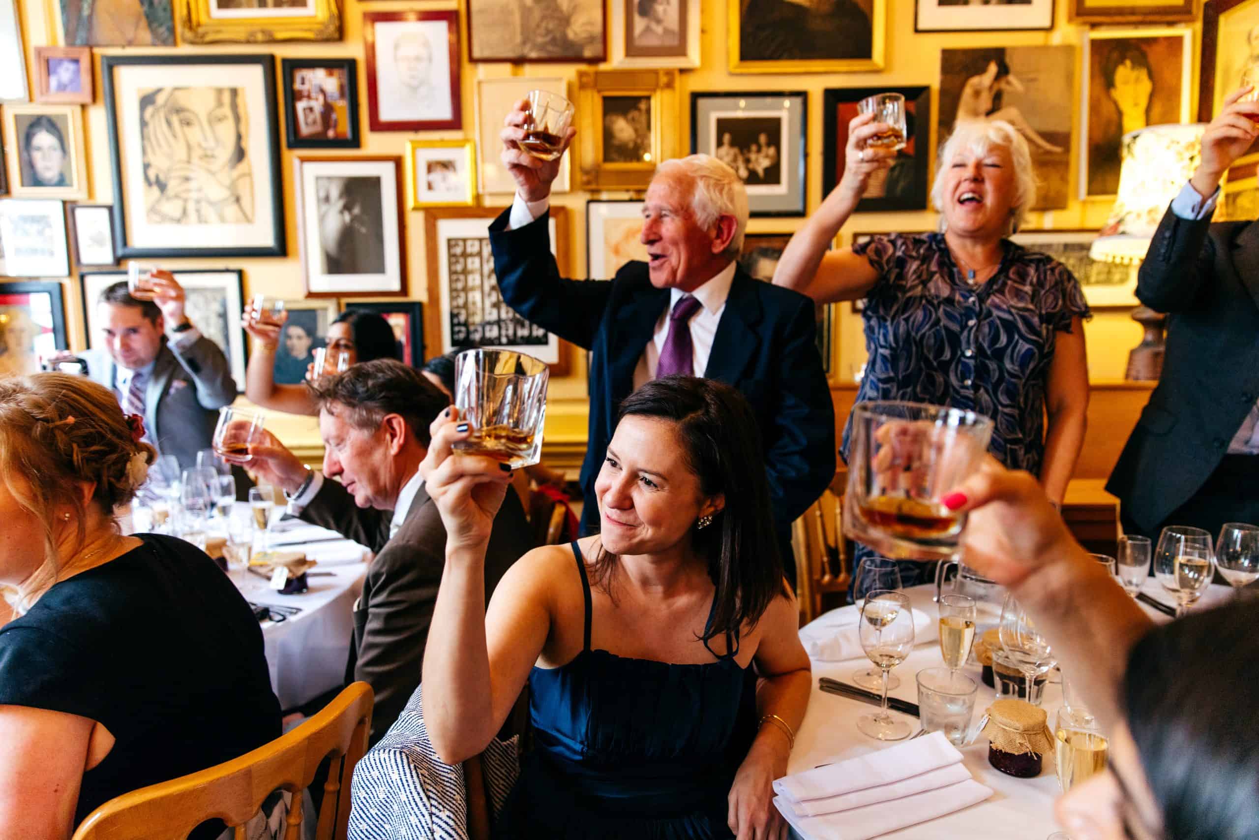 Guests cheer the happy couple at wedding at Union Club Soho Wedding.