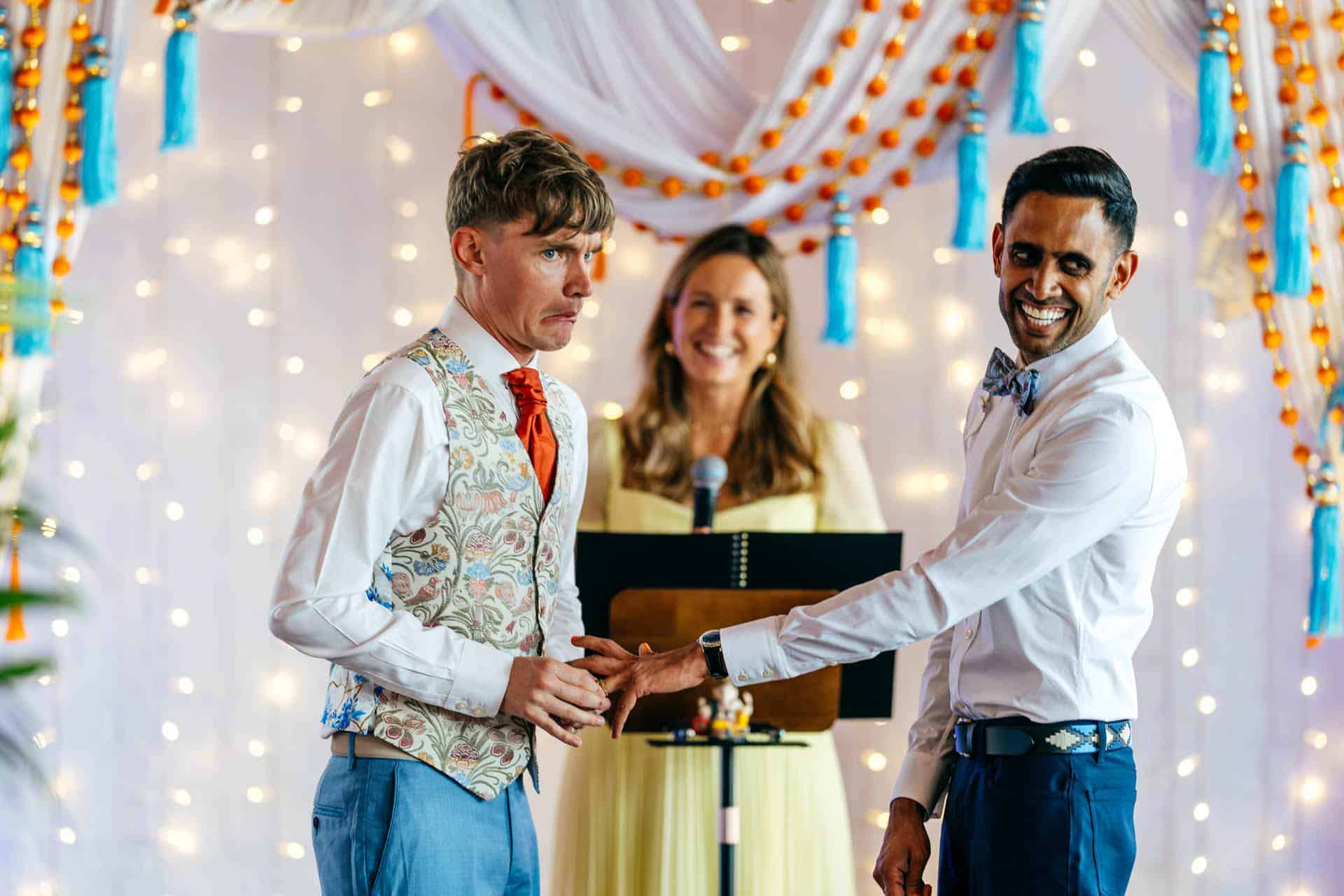 Groom struggling to get ring on partner's finger during humanist wedding at Trinity Buoy Wharf
