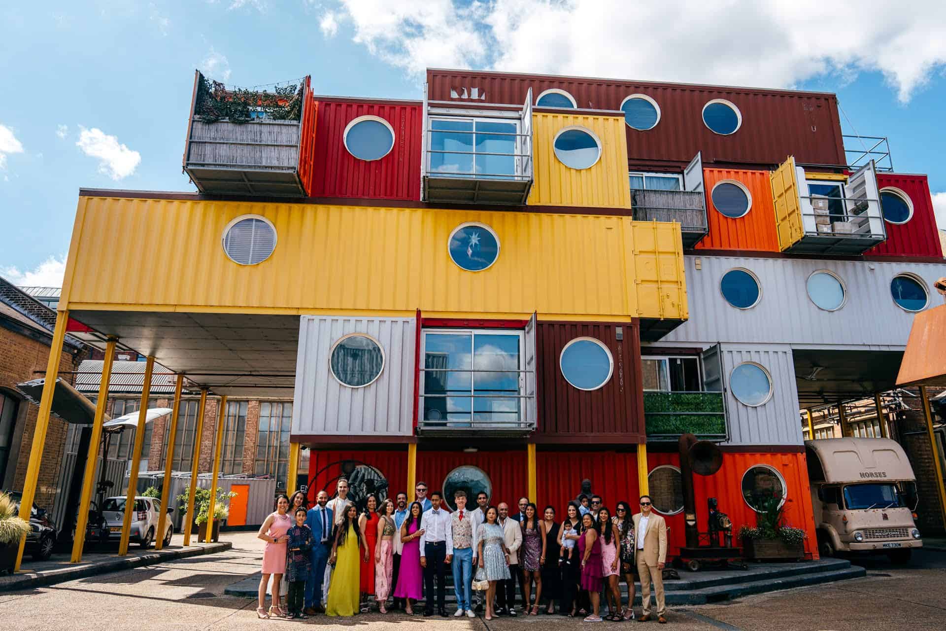 Family group shot in front of shipping container homes and art at Trinity Buoy Wharf
