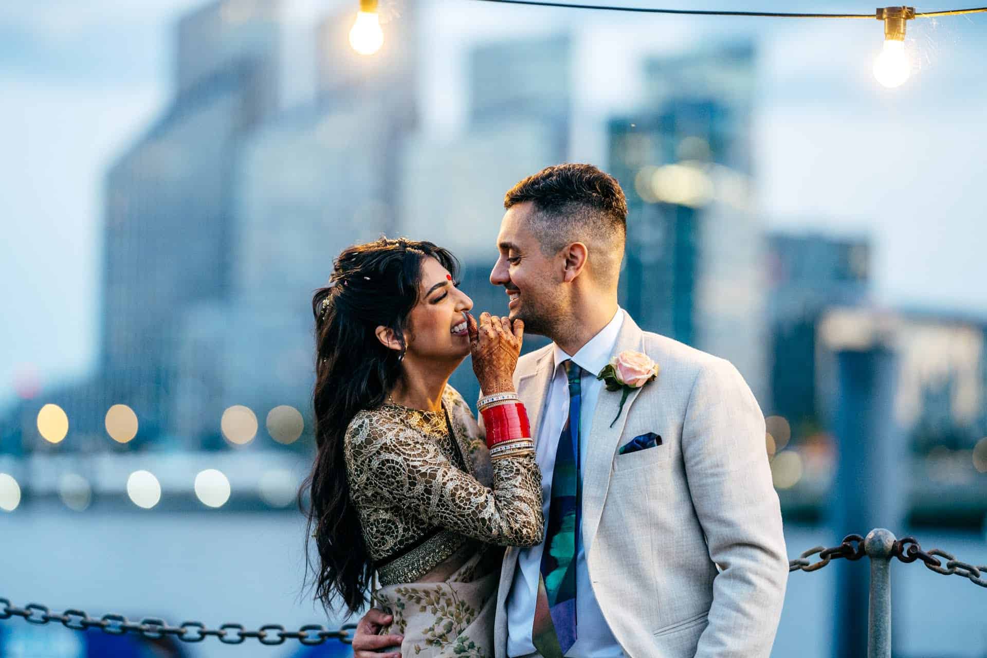 Couple laughing by the River Thames on the terrace at Trinity Buoy Wharf